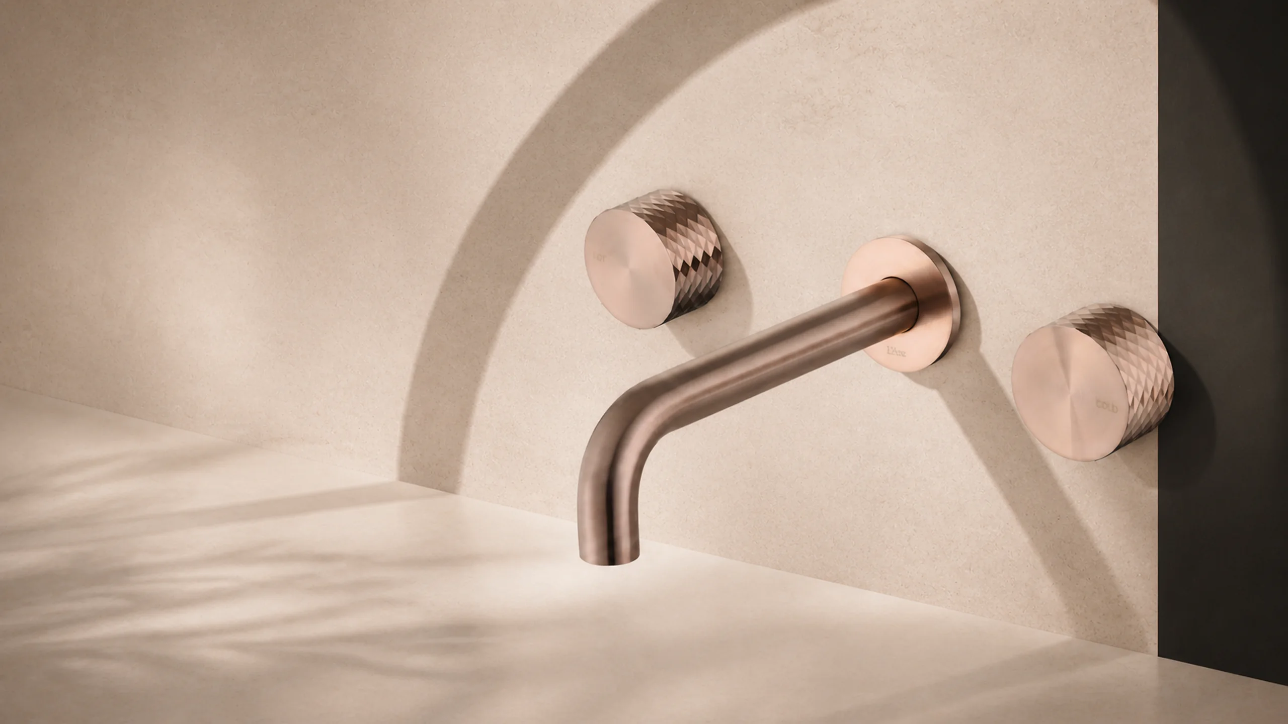 Noxara LA163 wall-mounted basin and bath mixer in brushed coffee gold
