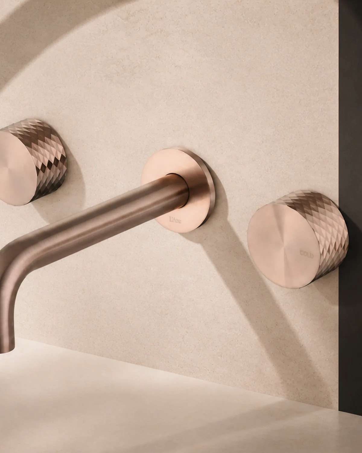 Noxara LA163 wall-mounted basin and bath mixer in brushed coffee gold